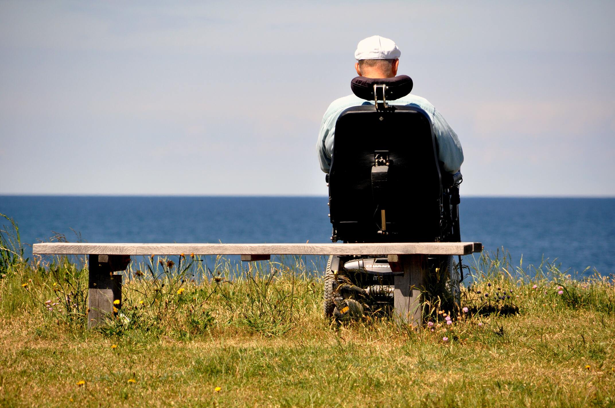 Person in wheelchair overlooking body of water. Used in the article about how sci affects your body's organs.