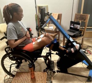 A woman using the MyoCycle in her home.